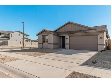 Single-story home with a two-car garage and neutral color scheme at 18411 W Monte Lindo Ln, Surprise, AZ 85387