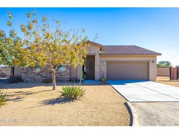 Single-story home with a two-car garage and desert landscaping at 19350 W Clarendon Ave, Litchfield Park, AZ 85340