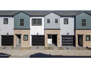 Three-unit townhome complex with modern brick exteriors and attached garages at 2820 W Eagle Talon Rd, Phoenix, AZ 85085