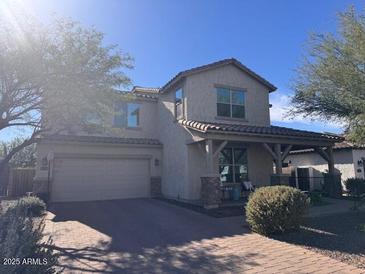 Charming two-story home featuring a two-car garage, covered porch, and nicely landscaped front yard at 3933 E Alfalfa Dr, Gilbert, AZ 85298