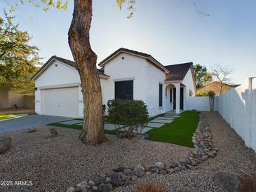 White stucco house with two-car garage and landscaped front yard at 4229 E Crest Ct, Gilbert, AZ 85298