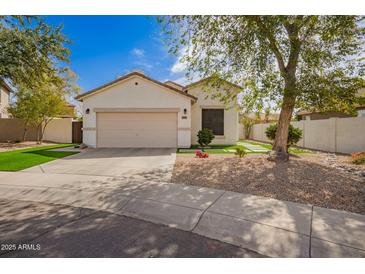 Charming single-story home with a two-car garage and a well-manicured front yard with fresh rock and synthetic grass at 4229 E Crest Ct, Gilbert, AZ 85298