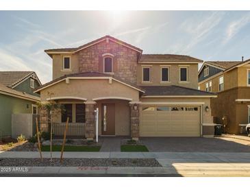 Two-story house with stone accents and a two-car garage at 4257 E John St, Gilbert, AZ 85295