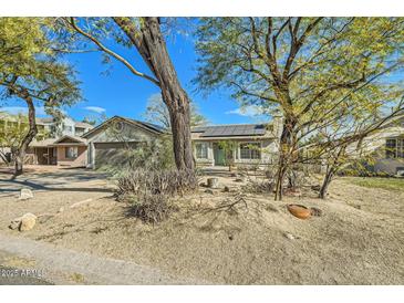 One-story home featuring a large front yard, solar panels, and desert landscaping at 4737 N 9Th St, Phoenix, AZ 85014