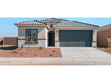 Charming single Gathering home featuring a tile roof, two car garage and low maintenance landscaping at 4817 S 251St Dr, Buckeye, AZ 85326