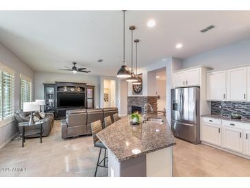 Open concept kitchen with granite island and living area at 5927 E Sienna Bouquet Pl, Cave Creek, AZ 85331