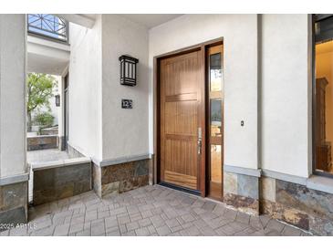 Inviting entryway with tiled flooring and access to the living area at 8 Biltmore Est # 123, Phoenix, AZ 85016