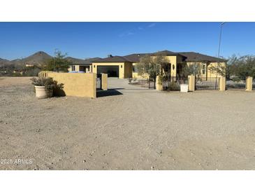 Desert landscape home with gated entry and large yard at 8210 S 132Nd Ave, Goodyear, AZ 85338