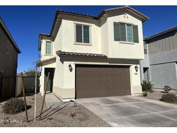 Two-story house with brown garage door and landscaping at 9408 E Supernova Dr, Mesa, AZ 85212