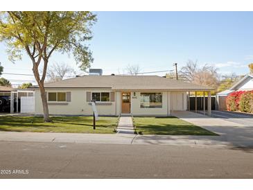 Updated mid-century home with landscaped lawn and driveway at 6642 N 10Th Ave, Phoenix, AZ 85013