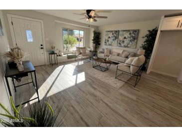 Bright living room with hardwood floors, comfy seating, and large windows at 8448 E Cambridge Ave, Scottsdale, AZ 85257