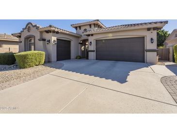 Spanish style home with a 3 car garage and manicured landscaping at 14113 W Windsor Ave, Goodyear, AZ 85395