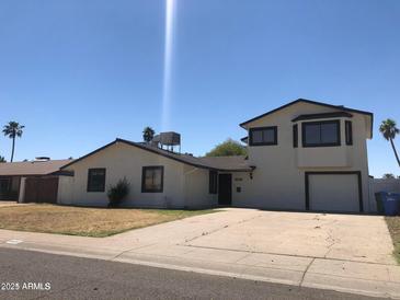 Two-story house with attached garage and landscaped front yard at 14408 N 36Th Ave, Phoenix, AZ 85053