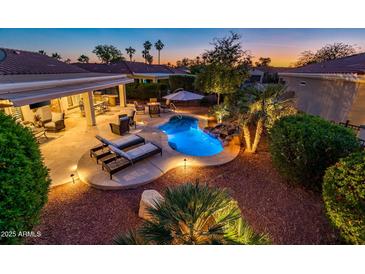 Inviting backyard oasis featuring a sparkling pool and patio area at 22012 N Arrellaga Dr, Sun City West, AZ 85375