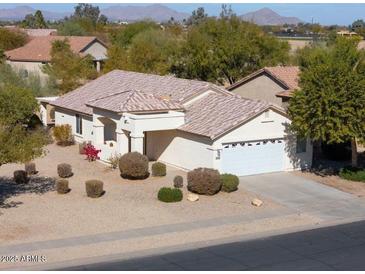 Aerial view of single-story house with desert landscaping, and mountain views in the background at 2490 E Fiesta Dr, Casa Grande, AZ 85194