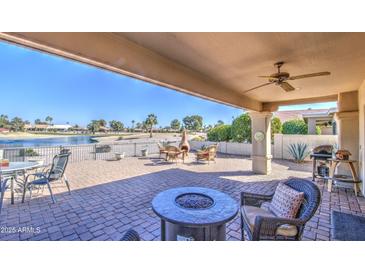 Large covered patio overlooking a lake and golf course at 26409 S Moonshadow Dr, Sun Lakes, AZ 85248