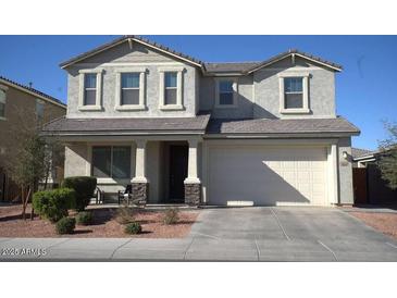 Two-story house with a large front yard, two-car garage, and neutral color scheme at 3094 N 195Th Dr, Buckeye, AZ 85396