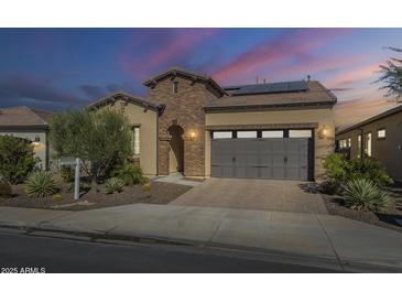 Stunning two-story home with brick accents and a solar panel system at 316 E Leverenz Ave, Queen Creek, AZ 85140