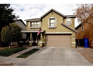 Two-story house with tan exterior, two-car garage, and small front yard at 3432 E Bartlett Dr, Gilbert, AZ 85234