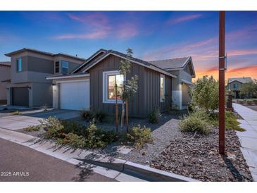 Single-story home with attached garage, landscaping, and a modern exterior design at 4802 S Duffy --, Mesa, AZ 85212