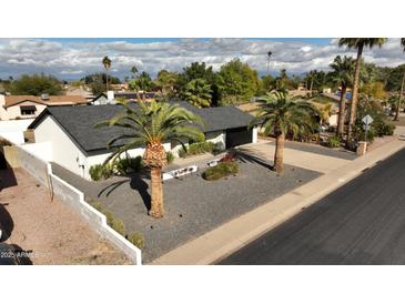 Attractive single-level home with a landscaped yard and two palm trees at 4916 E Kathleen Rd, Scottsdale, AZ 85254