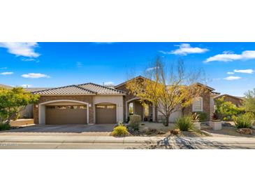 Beautiful two-story home with stone accents and landscaped yard at 6033 E Pebbles Ct, Cave Creek, AZ 85331