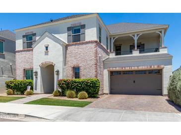 Two-story home with brick accents and a landscaped front yard at 630 W Echo Ln, Phoenix, AZ 85021