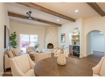 Bright living room with fireplace, high ceilings, and built-in bar at 6425 N 79Th St, Scottsdale, AZ 85250