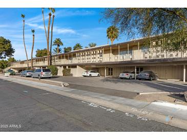 Building exterior showcasing ample parking and a well-maintained landscape at 725 S Power Rd # 214, Mesa, AZ 85206