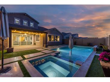 Stunning backyard oasis with a sparkling pool, spa, and covered patio at 10538 E Sheffield Dr, Mesa, AZ 85212