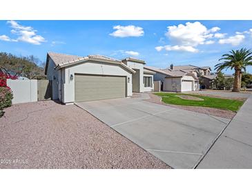 Single-story home with a two-car garage and well-manicured lawn at 1082 W Aspen Ave, Gilbert, AZ 85233