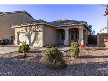 One-story house with a two-car garage and landscaped front yard at 12418 W Pima St, Avondale, AZ 85323