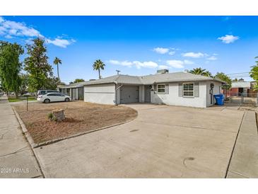 Single story home with attached garage and front yard at 1312 E Colter St, Phoenix, AZ 85014