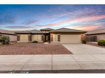 Single-story home with tile roof, attached garage, and desert landscaping at 13292 W Statler St, Surprise, AZ 85374