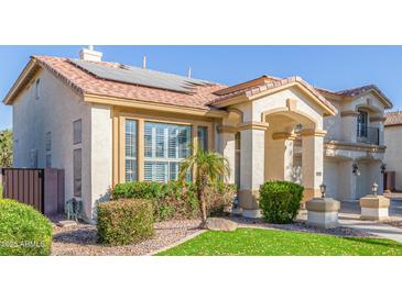 Two-story house with solar panels, landscaped yard, and two-car garage at 1684 E Coconino Dr, Chandler, AZ 85249