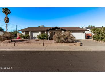 Single-story home with a two-car garage and well-maintained landscaping at 3146 S Stewart Cir, Mesa, AZ 85202