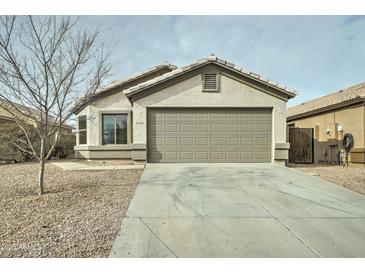 Single-story house with a two-car garage and a gravel driveway at 33868 N Mercedes Dr, San Tan Valley, AZ 85144