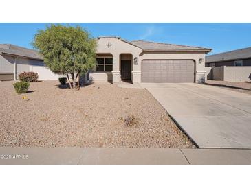 One-story house with desert landscaping and a two-car garage at 36148 W Seville Dr, Maricopa, AZ 85138