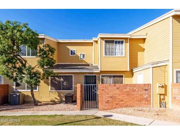 Front view of a yellow two-story townhome with a gated entrance at 510 N Alma School Rd # 158, Mesa, AZ 85201