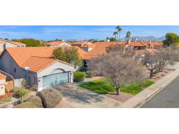 Single-story home with a terracotta roof, and a spacious yard at 5714 E Paradise Ln, Scottsdale, AZ 85254