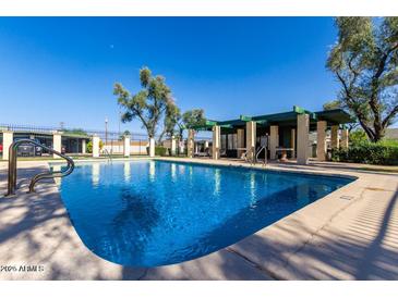 Community pool with covered patio and lounge chairs at 6508 N 24Th Ln, Phoenix, AZ 85015