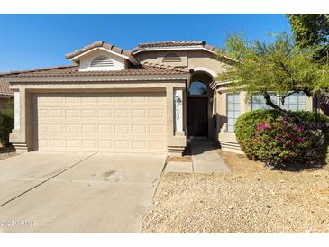 Single-story house with a two-car garage and landscaped yard at 6602 W Prickly Pear Trl, Phoenix, AZ 85083