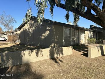 Tan single story home with walkway and small yard at 6711 W Osborn Rd # 96, Phoenix, AZ 85033