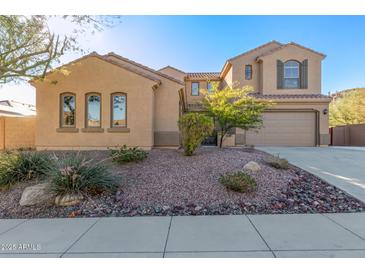 Two-story house with desert landscaping and a three-car garage at 6857 W Juana Dr, Peoria, AZ 85383