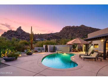 Luxury pool with mountain views and lounge chairs at 7002 E Leisure Ln, Carefree, AZ 85377