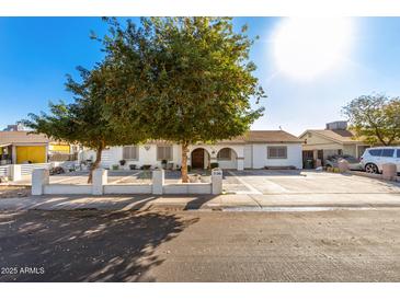 Single-story home with landscaped yard and driveway at 7135 W Heatherbrae Dr, Phoenix, AZ 85033