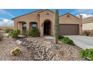 Single-story home with desert landscaping and two-car garage at 8047 W Cinder Brook Way, Florence, AZ 85132