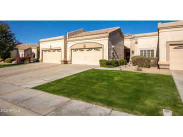 Two-car garage, well-maintained landscaping, and a charming facade at 8392 W Oraibi Dr, Peoria, AZ 85382