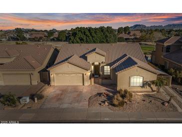 Tan two-story house with tile roof, two-car garage, and landscaped front yard at 9758 E Meseto Ave, Mesa, AZ 85209