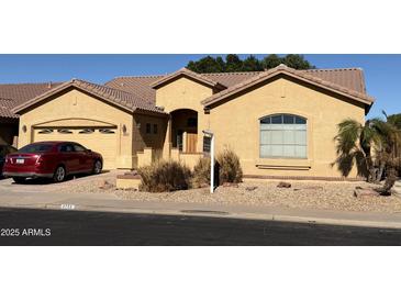 Single-story home with a two-car garage and landscaped front yard at 9758 E Meseto Ave, Mesa, AZ 85209